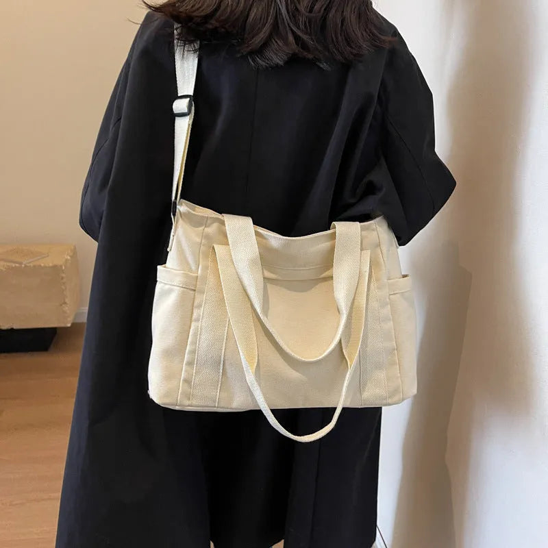 Large solid colour polyester shoulder tote bag with external pocket and internal phone compartment