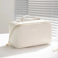 Vertical pattern pillow makeup bag in a cubic shape with large capacity for travel storage.