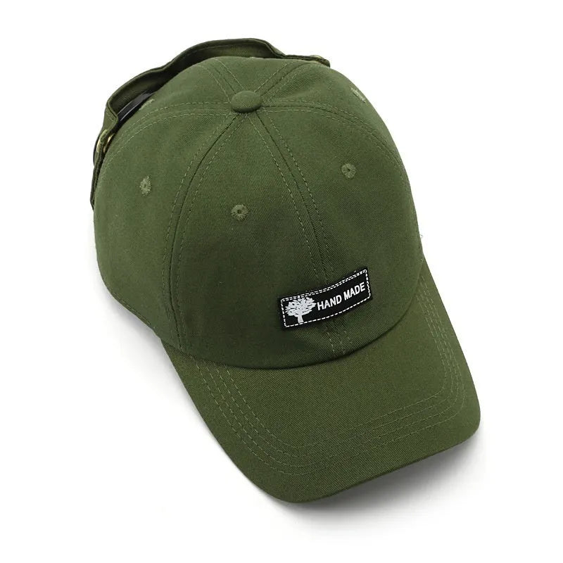 Men's cotton peaked cap in free size with dome crown, satin processing, and letter detailing, shown in monochrome design.