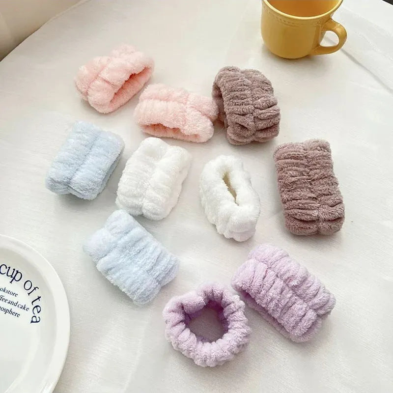 Coral velvet wrist washbands in white, pink, light blue, grey, and lavender for face washing and beauty routines.