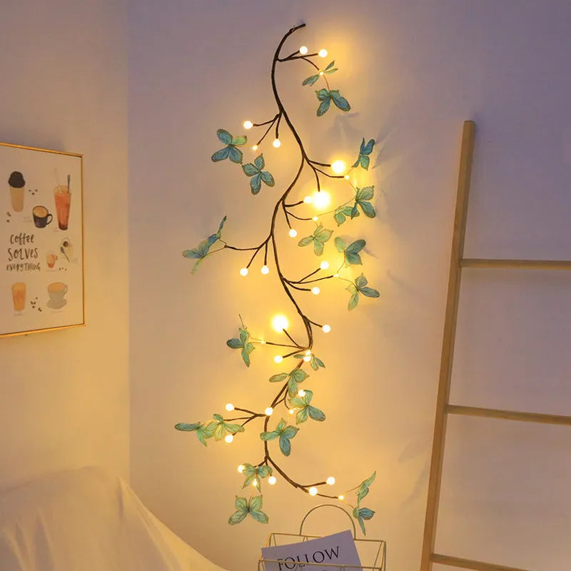 Flexible LED butterfly tree rattan lamp shaped into a decorative spiral, showing USB cable and lit white LEDs.