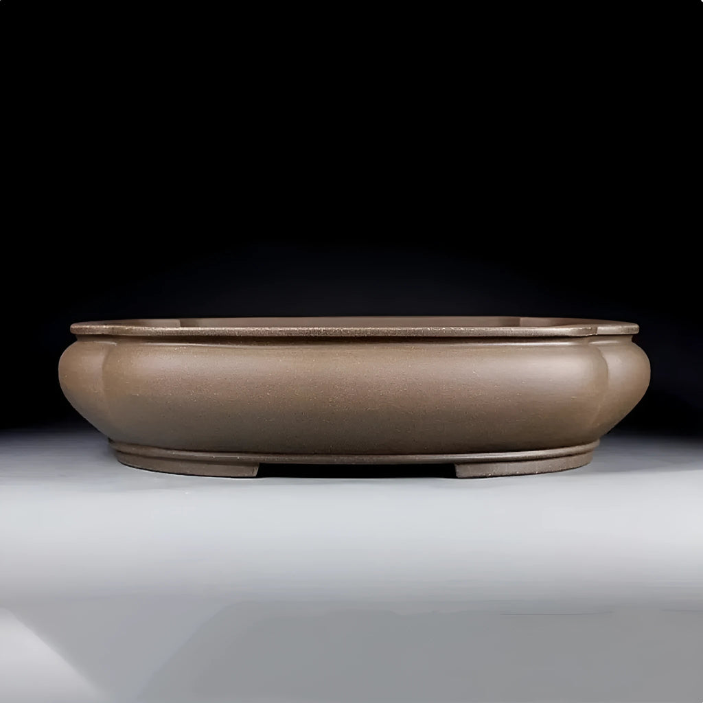 Handmade antique Pukou style papaya-shaped purple clay flower pot on a table.