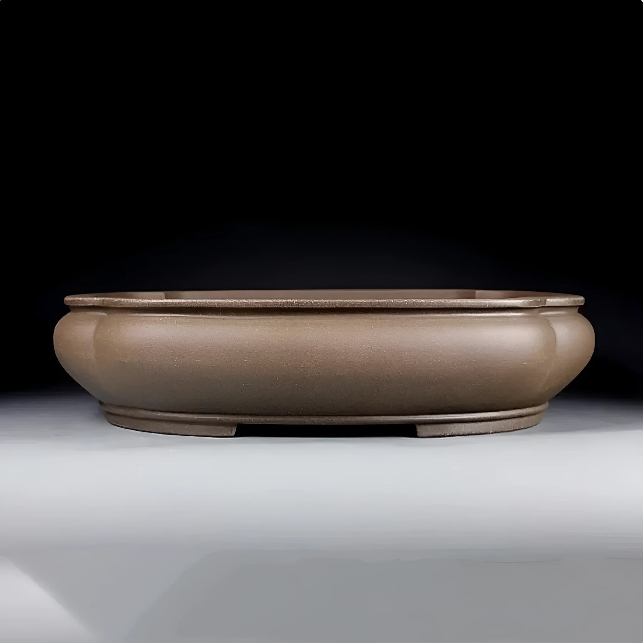 Handmade antique Pukou style papaya-shaped purple clay flower pot on a table.