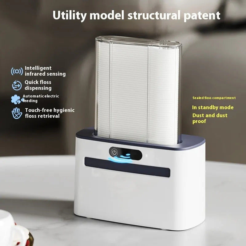 Dark gray automatic dental floss box with USB charging port and pop-up floss dispenser.