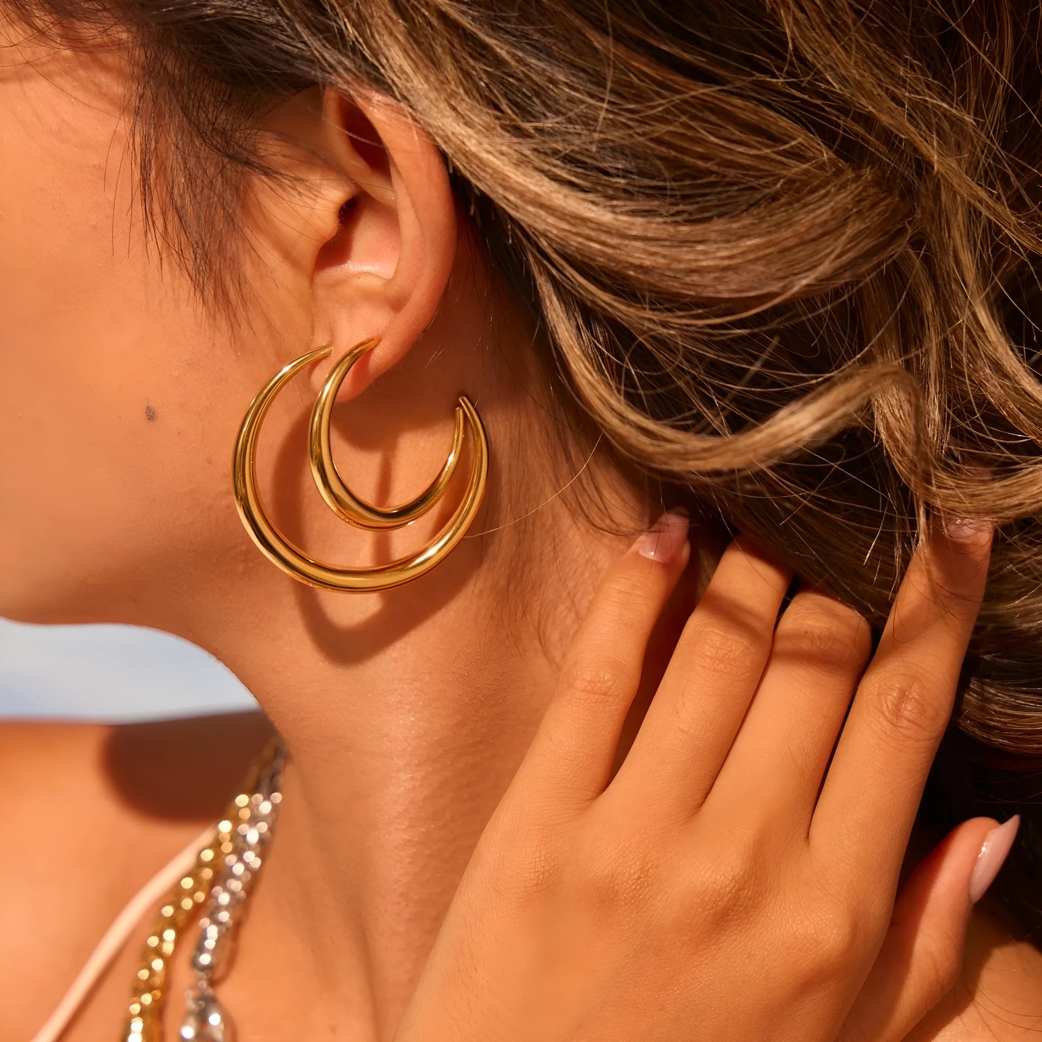 Geometric titanium steel hoop earrings for women in gold and steel finishes with round design elements