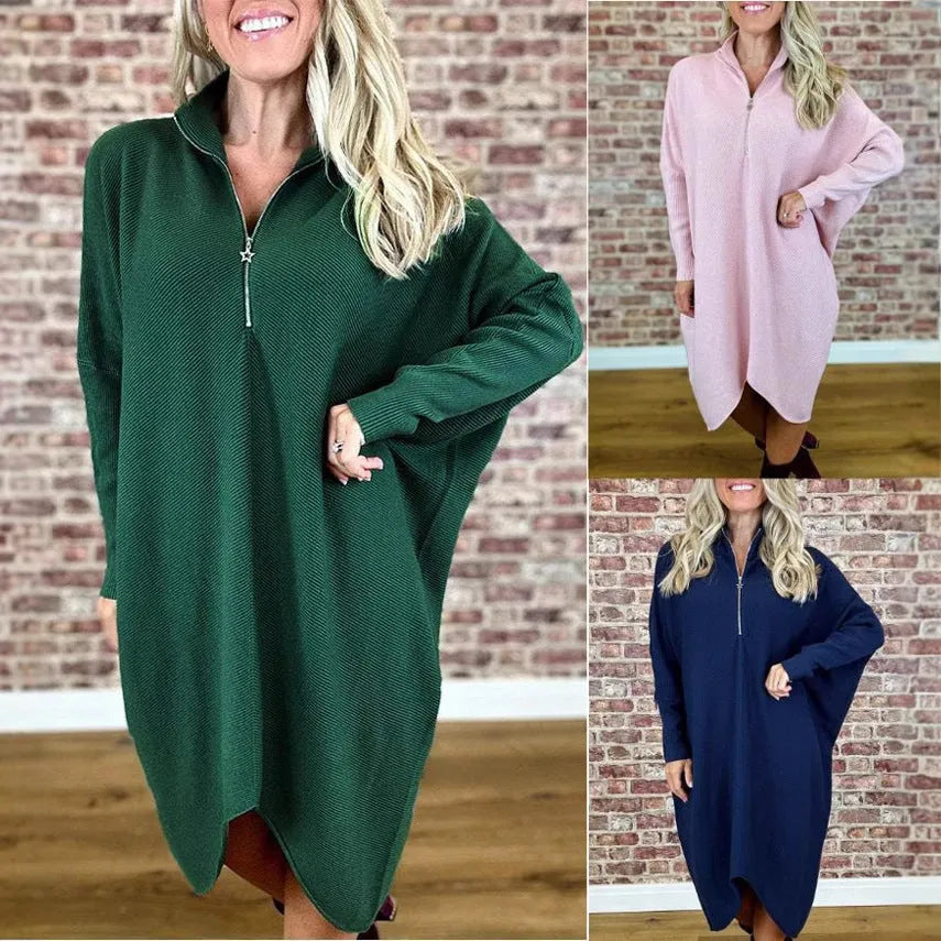 Women's solid colour loose fit knitted dress with raglan sleeves on a hanger.