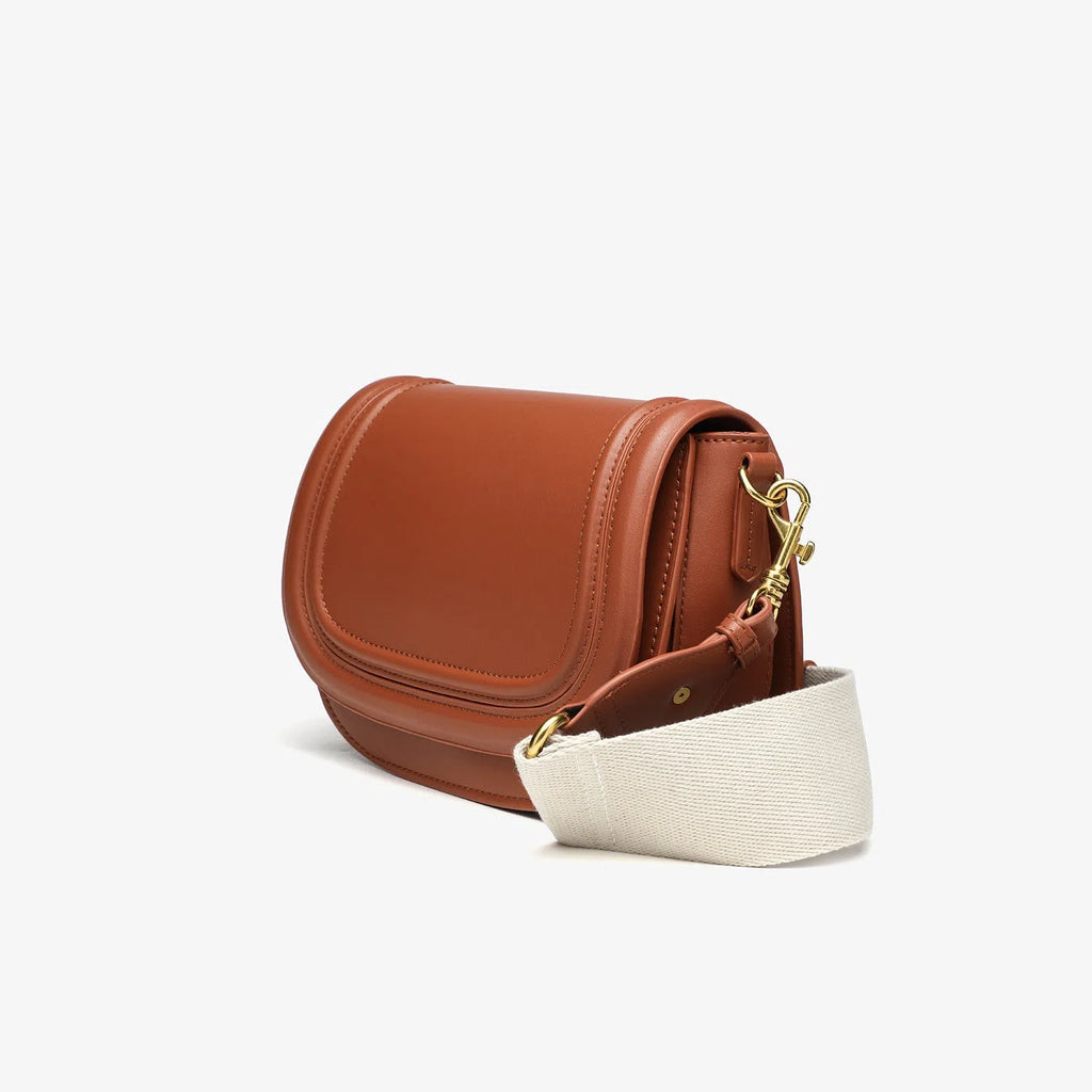 New women's crossbody bag with wide shoulder strap in PU leather, round flap shape, available in black