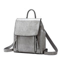 A large black genuine cowhide leather women's backpack with double shoulder straps, shown open to reveal internal zipper and document pockets.