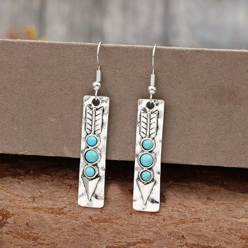 Silver geometric drop earrings with turquoise inlay detailing on long strip design