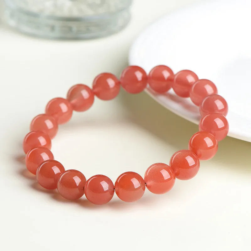 Natural South Red Cherry Agate scattered bead bracelet showing polished gemstone beads on a wrist.