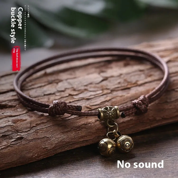 Nylon rope dog collar with brass bell and buckle on a grey background, showing black, red, and coffee colour options.