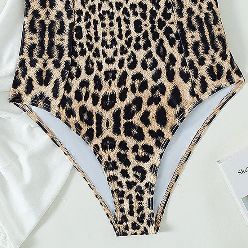 Leopard print one piece swimsuit with adjustable shoulder strap on woman at poolside