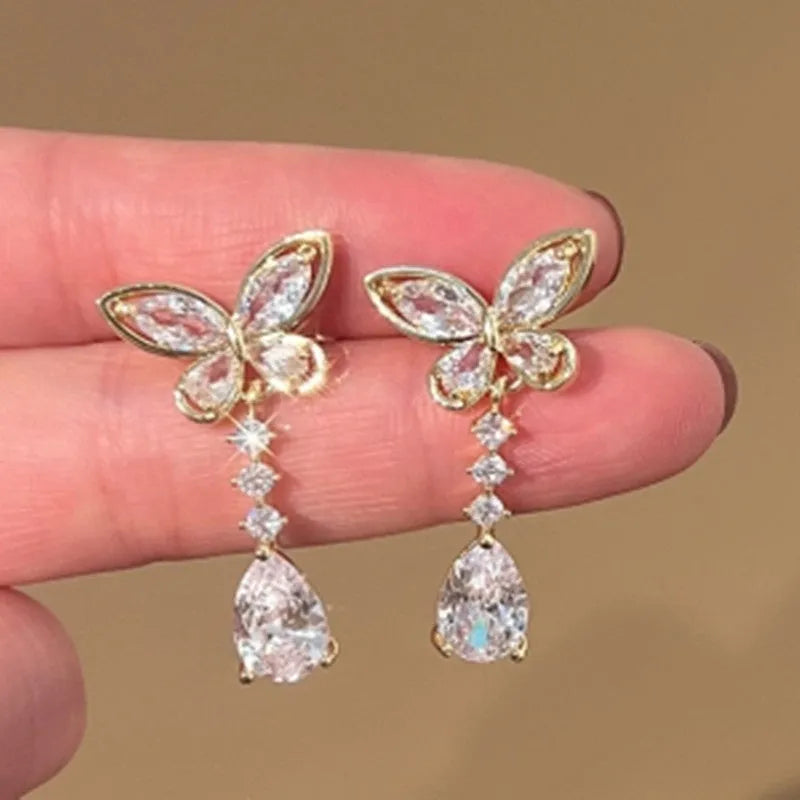Women's zinc alloy bow stud earrings in platinum colour with electroplated finish, laid flat