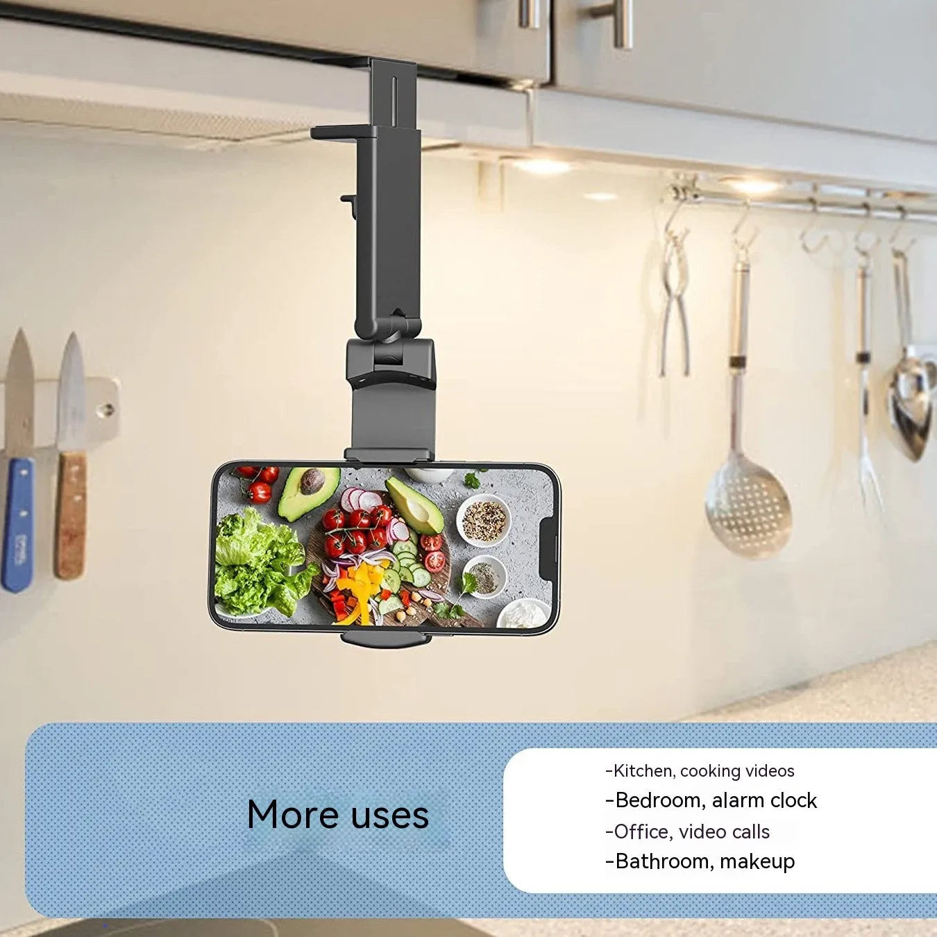 Black foldable rotating universal phone holder made of ABS plastic on a table.