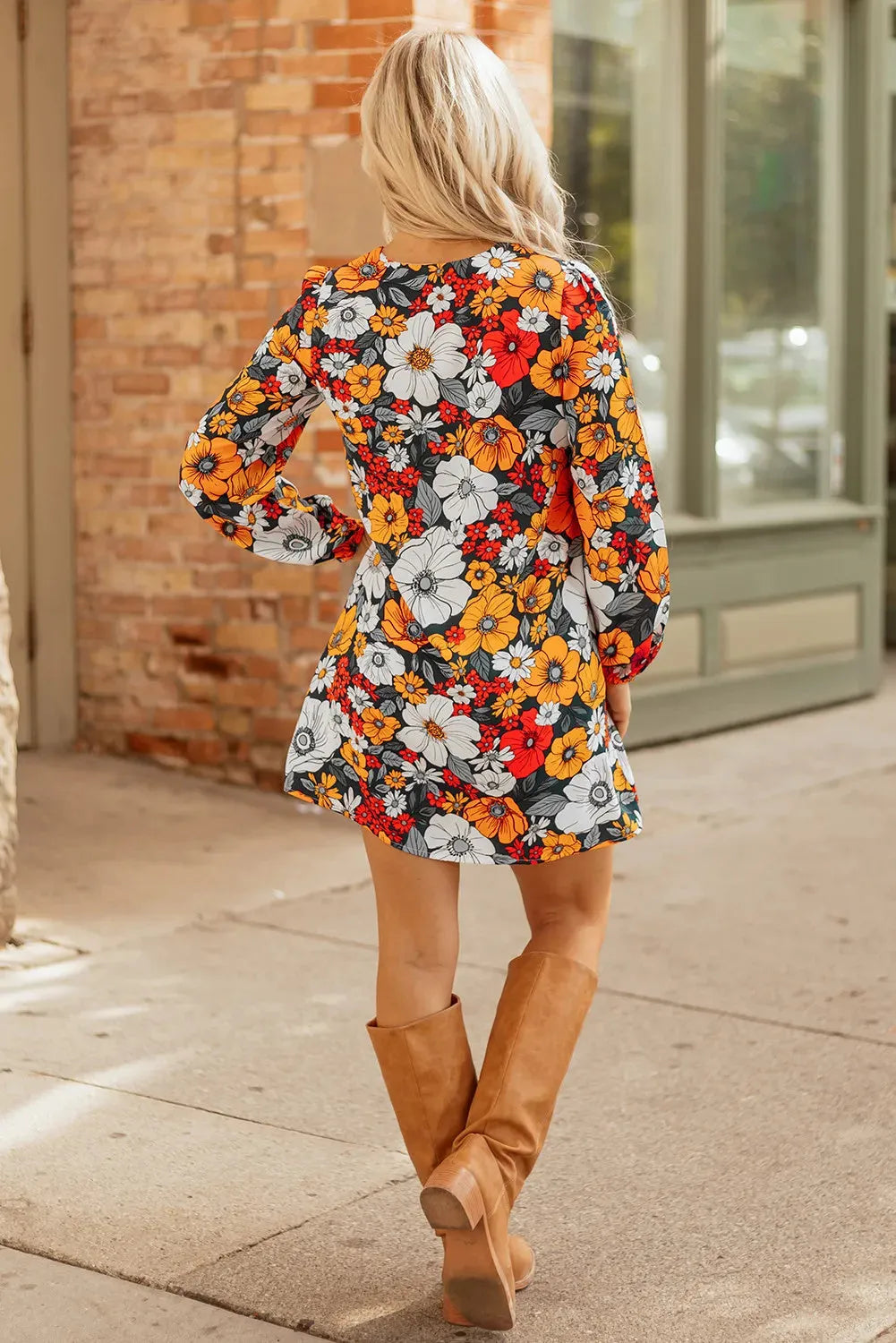 Orange floral print mini dress with lace trim, V-neck, and long sleeves on a hanger.