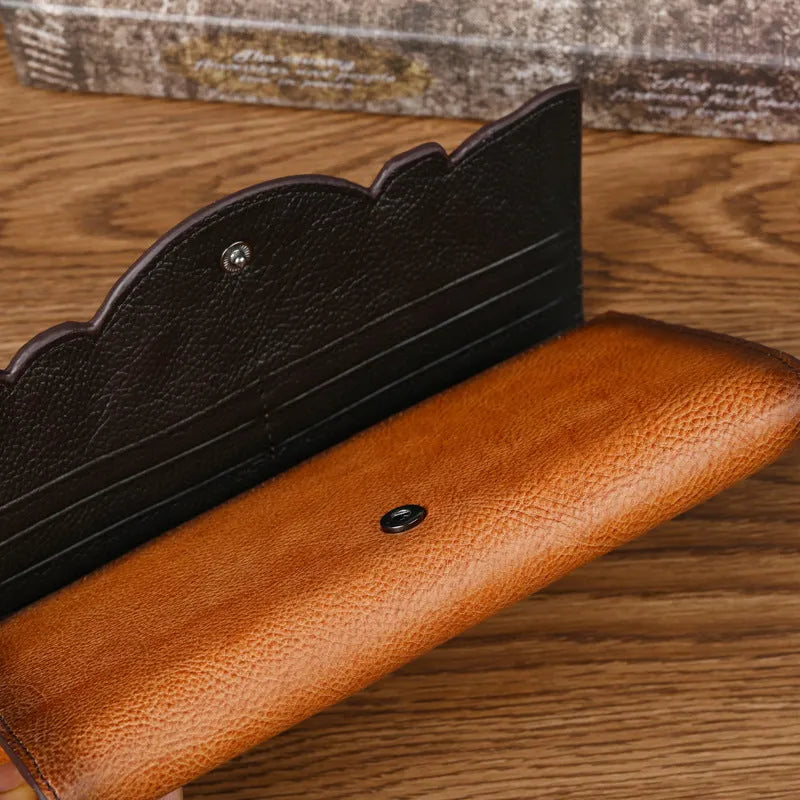 Chinese style brown embossed floral tri-fold women's wallet made from first layer cowhide, shown open and closed.