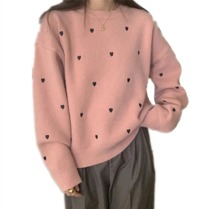 Women's loose beige acrylic pullover sweater with embroidered red love heart design on the chest.