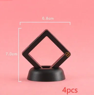 3D floating display case holding a coin suspended between transparent membrane sheets, black frame