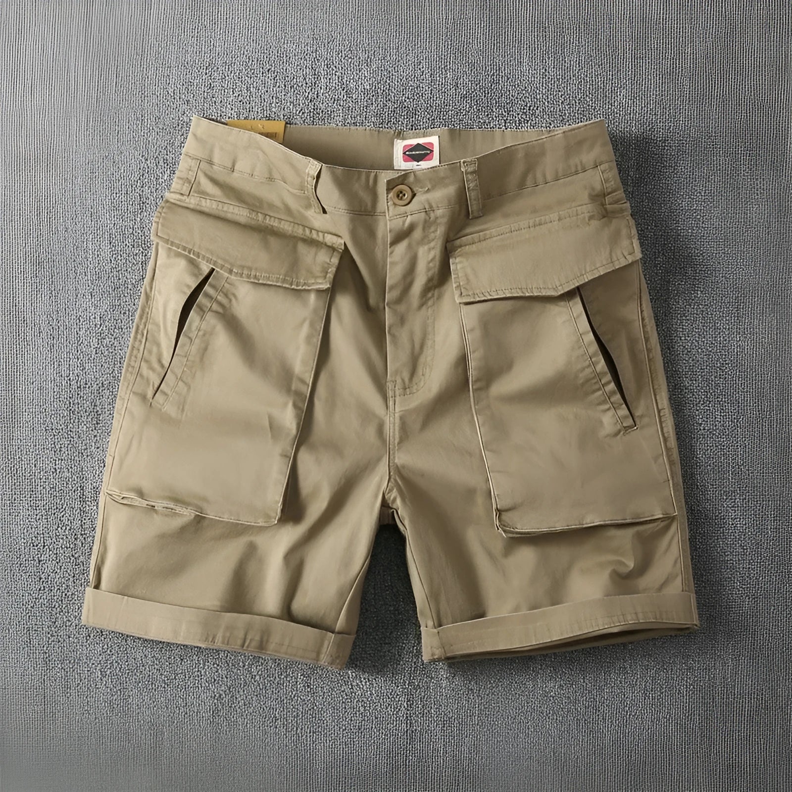 Men's straight-leg cotton cargo shorts in khaki with multiple pockets, shown on a model for summer street style.