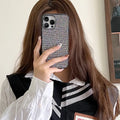 Rhinestone all-inclusive iPhone case in white or black with leather-style matte finish and fall prevention design.