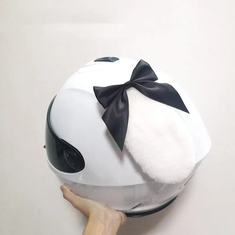 Carbon fibre rabbit ear decoration clipped onto a black motorcycle helmet, showing red colour variant.