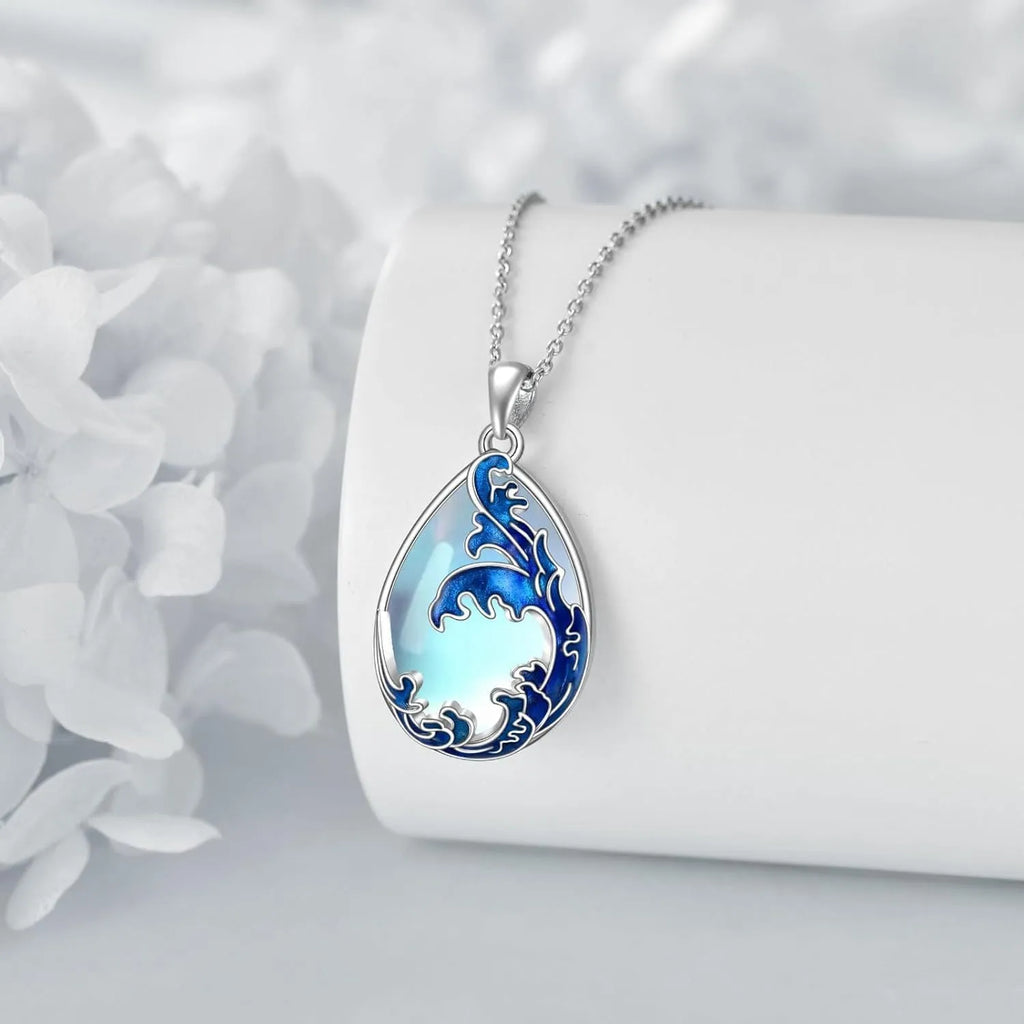 Close-up of a moonstone blue alloy heart pendant necklace on a 20-inch chain.