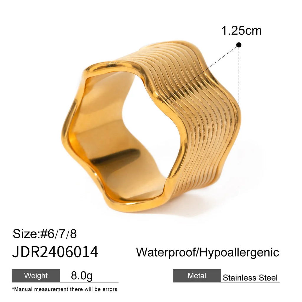 Stainless steel wide band wave ring in geometric Korean style on a plain background.