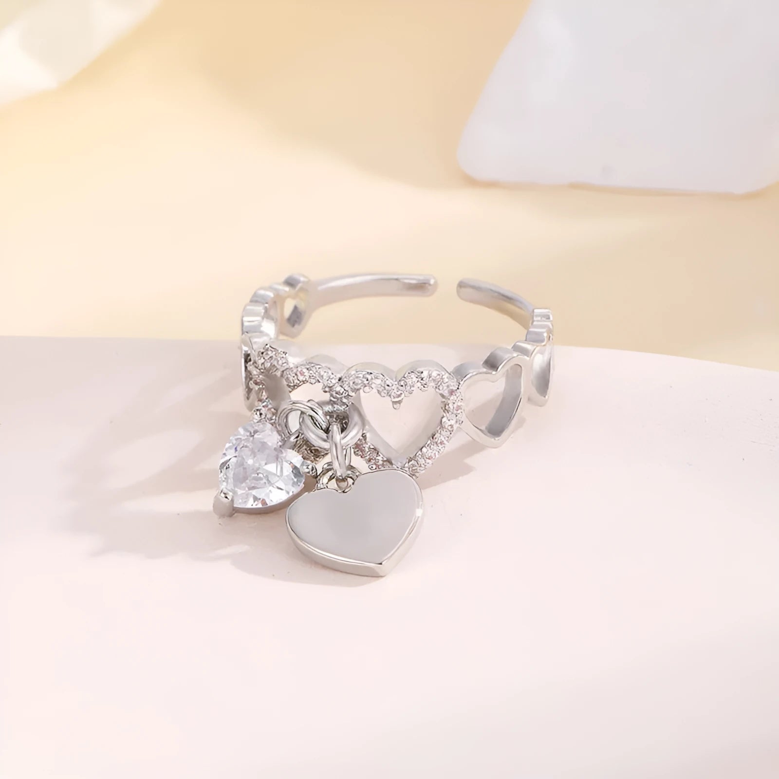 Silver electroplated copper adjustable heart ring for women on white background