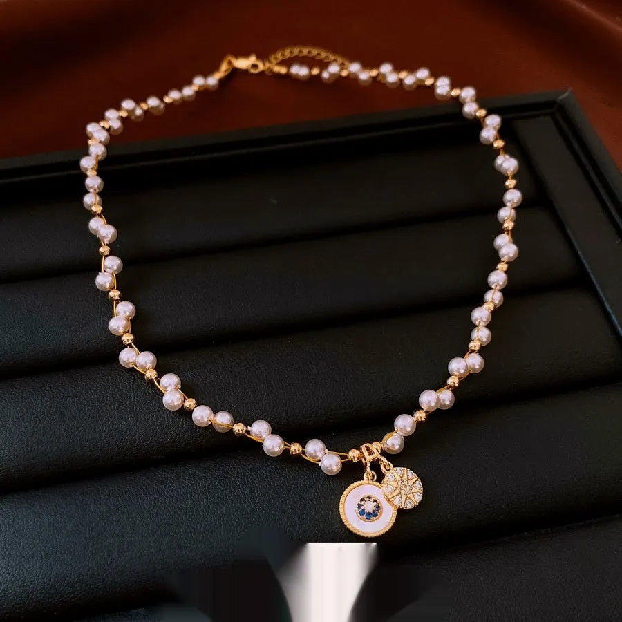 Gold electroplated necklace with round zircon and imitation pearl pendant on clavicle chain
