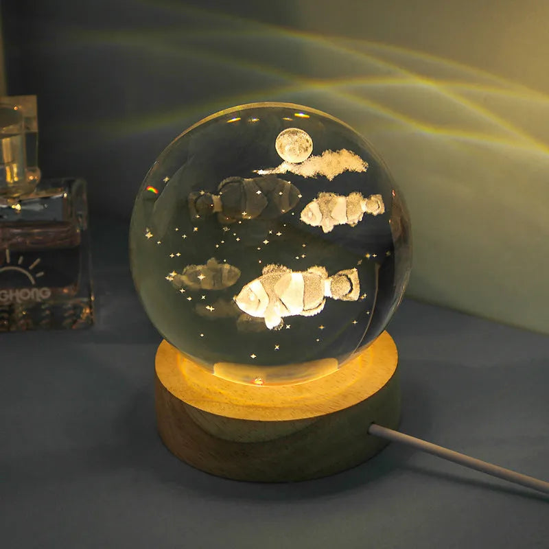 Transparent crystal ball night lamp with 3D carved jellyfish design, on a round base with USB cable.