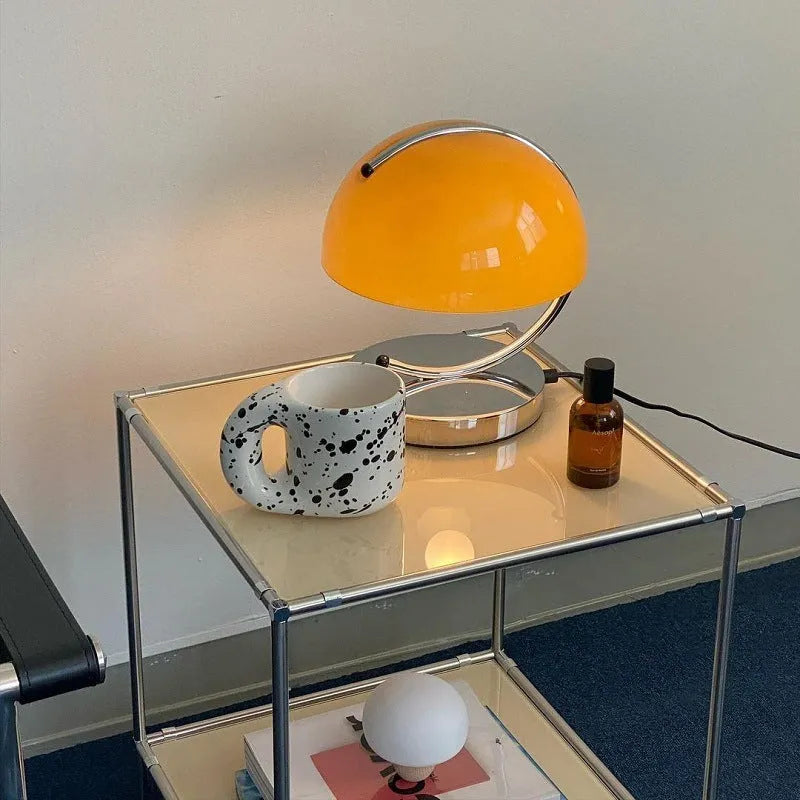 Retro space age table lamp with glass shade, LED light source, push button switch, available in orange or white.