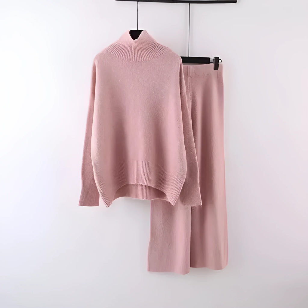 Women's beige acrylic knit long-sleeve sweater and matching wide-leg trousers set on a hanger.