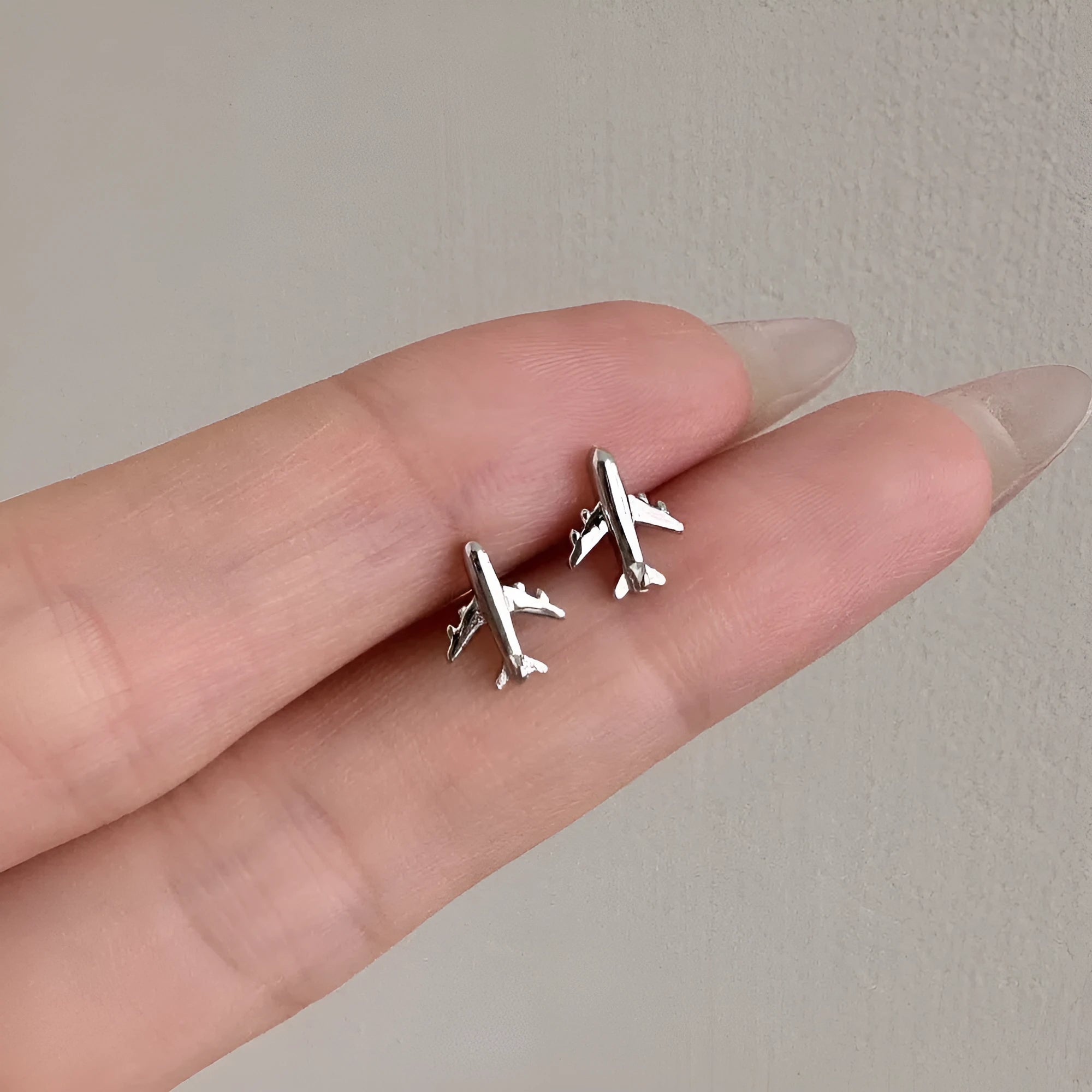 Pair of S925 sterling silver stud earrings with aircraft design in platinum finish