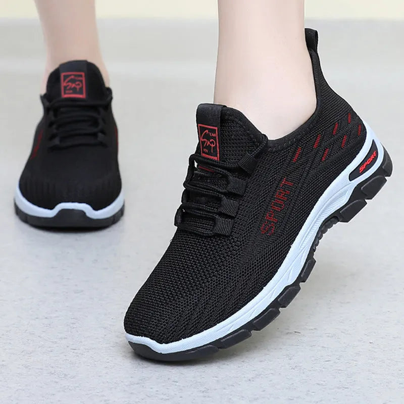 Men's and women's low-top casual sneakers with soft PVC sole in black, brown, grey, light purple, and red.