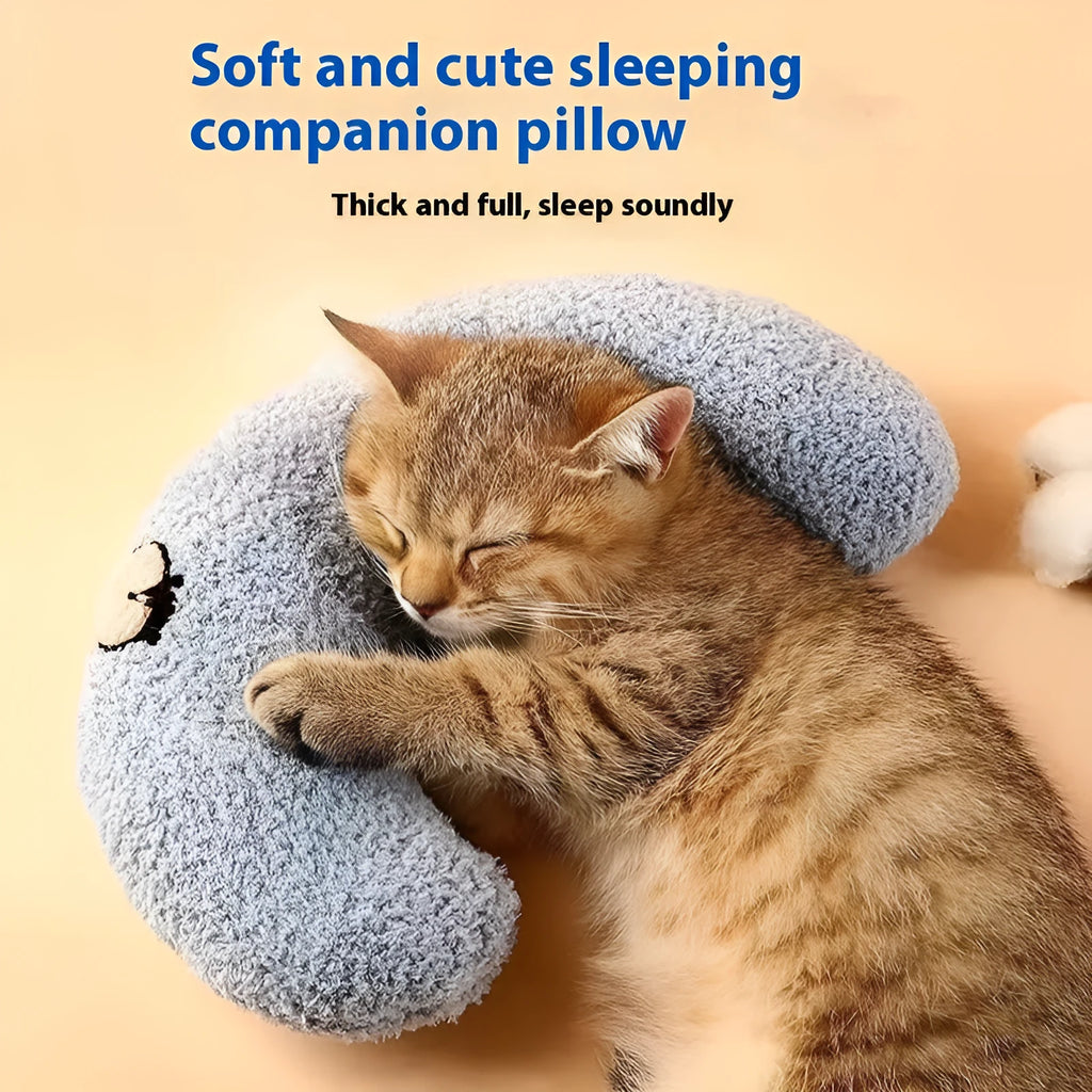 Blue U-shaped cat pillow with neck support in a moon design on a wooden floor.