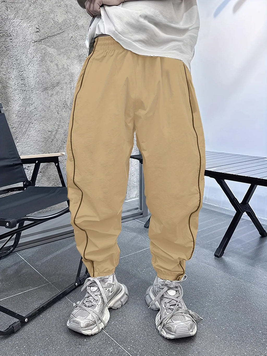Men's blue bamboo fibre casual sports trousers with a loose, cropped fit on a neutral background.