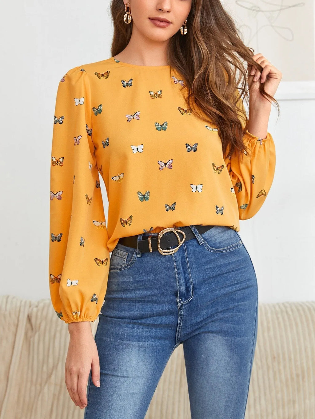 Women's green long-sleeved loose shirt with butterfly print pattern.