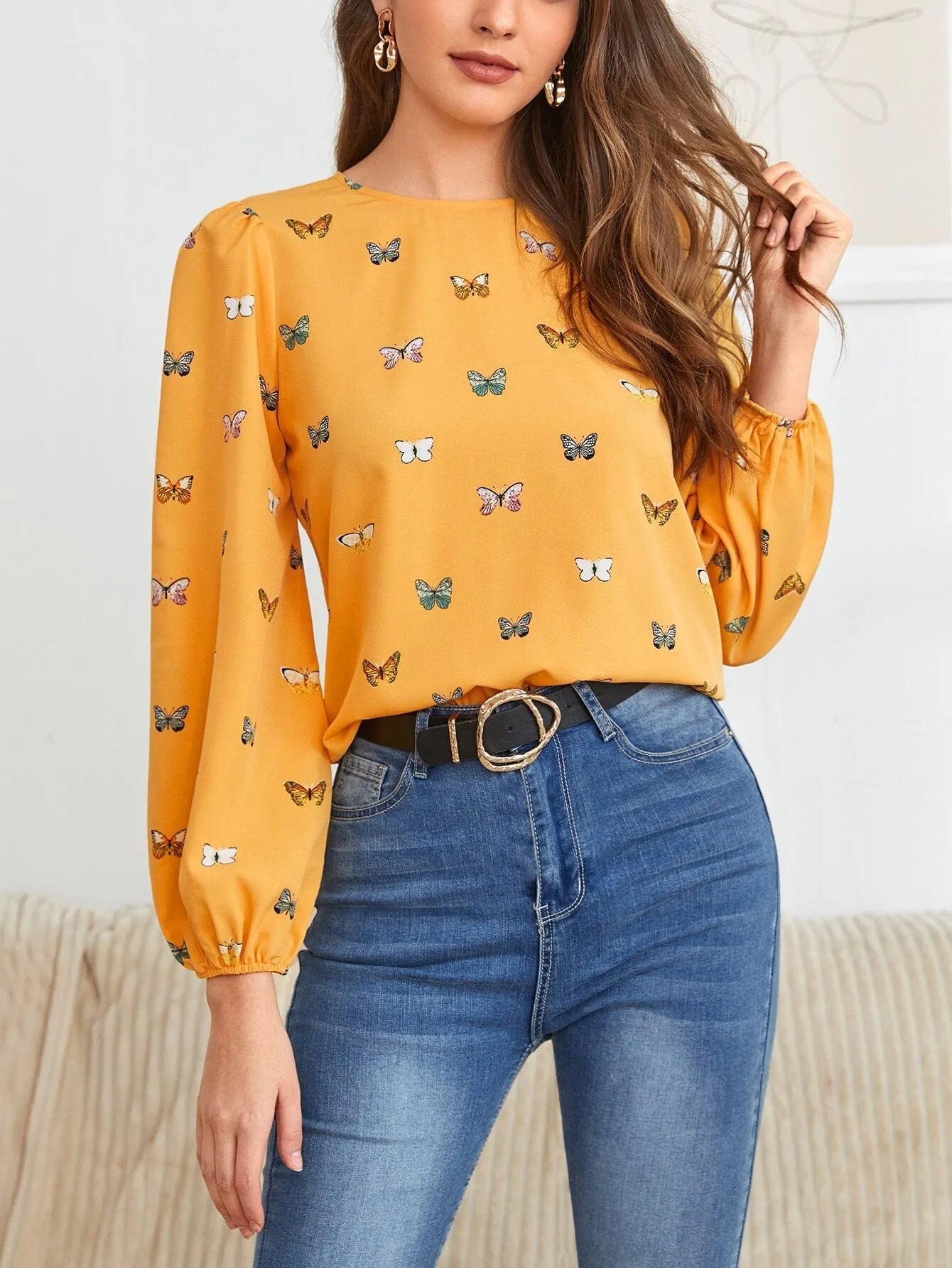 Women's green long-sleeved loose shirt with butterfly print pattern.