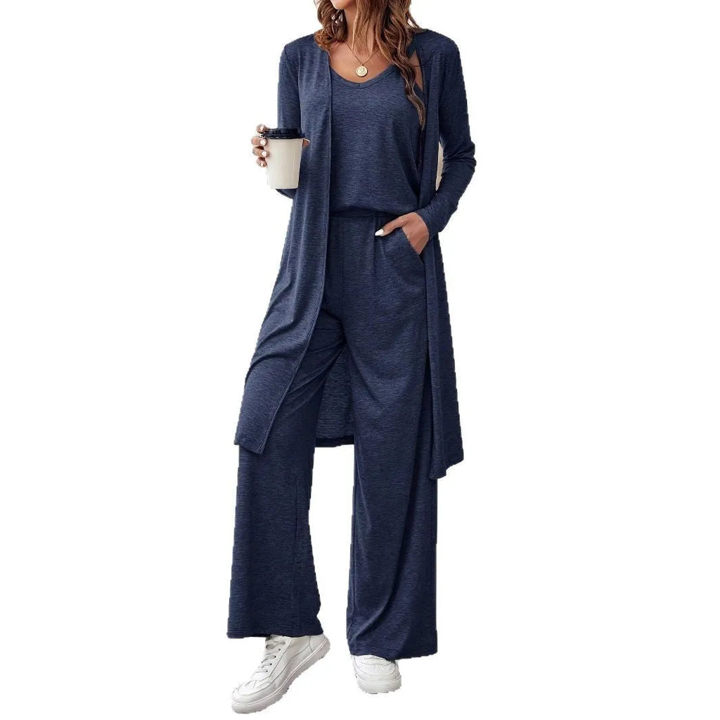 Blue women's three-piece suit with sling top, long cardigan, trousers, and suspenders on a mannequin.