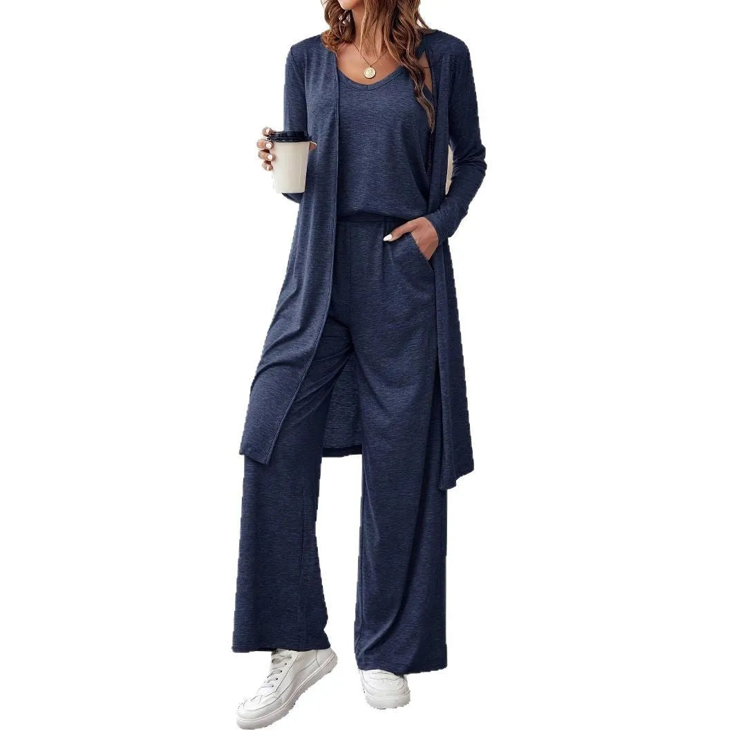 Blue women's three-piece suit with sling top, long cardigan, trousers, and suspenders on a mannequin.