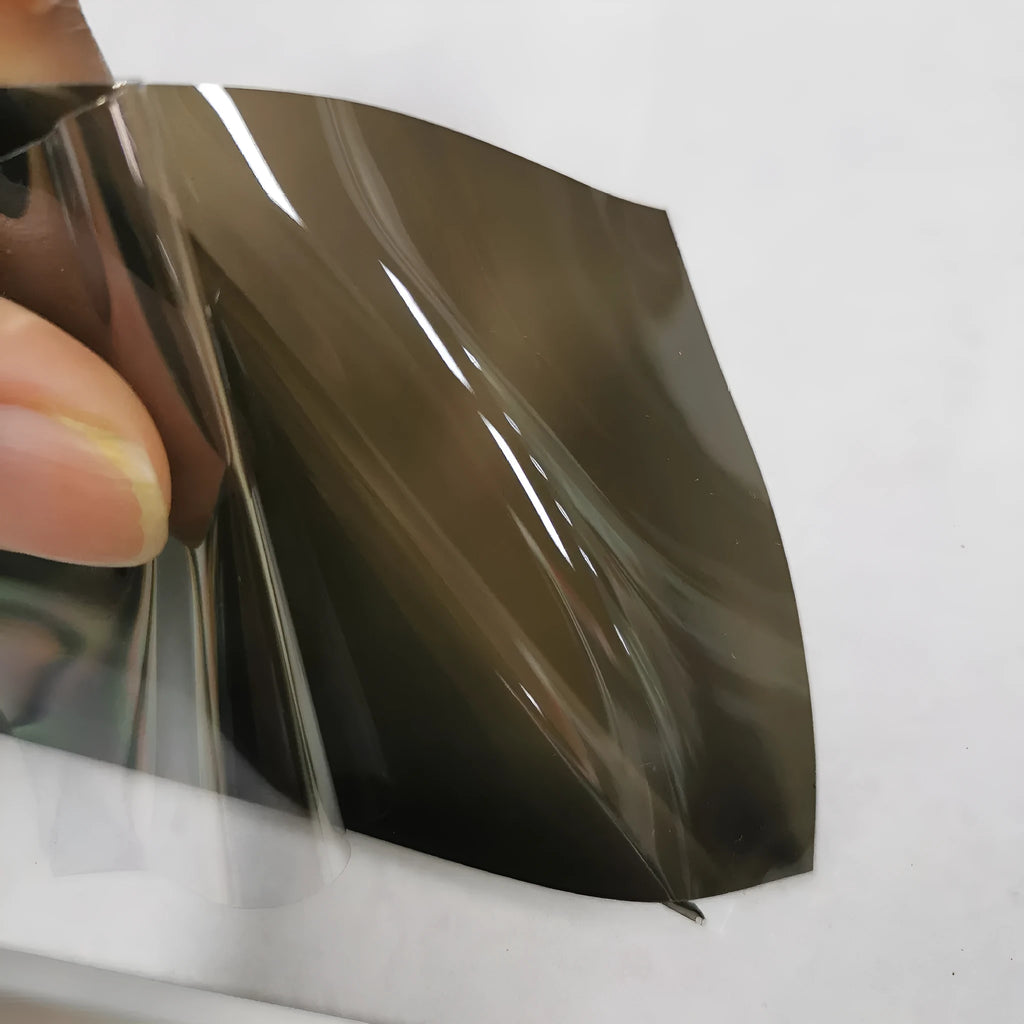 Roll of 30cm wide dark grey TPU protective film for car LED lamp protection.
