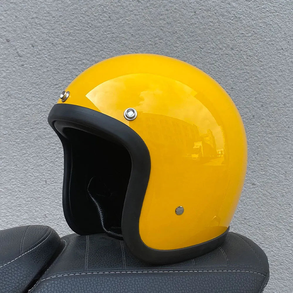 Retro-style open-face motorcycle helmet in matte black with floral design, showing clear visor and interior padding.