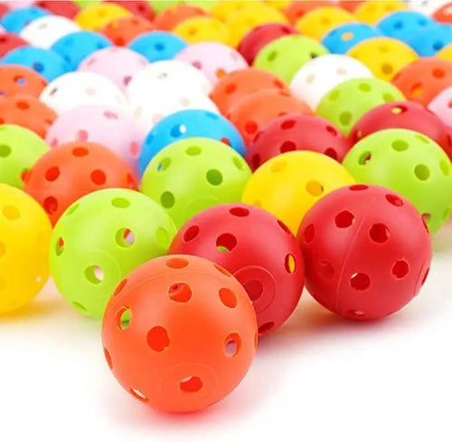 Assorted multi-colour 42mm golf practice balls with a net bag, shown next to practice putting holes.