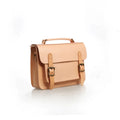 Hand made leather crossbeam bag in primary colour with full-grain cowhide exterior and leather lining, side view showing structured shape