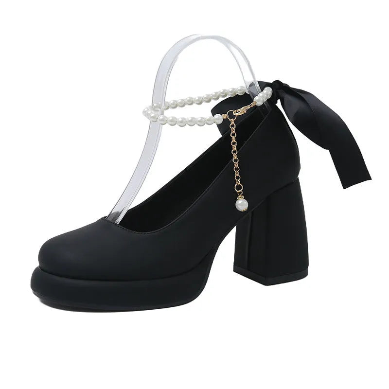Women's beige Mary Jane shoes with a chunky block heel and an ankle-strap buckle.