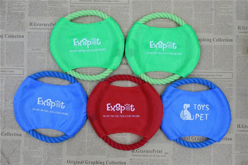 Canvas and rope dog flying disc toy with rain silk surface, 19cm diameter, on grass