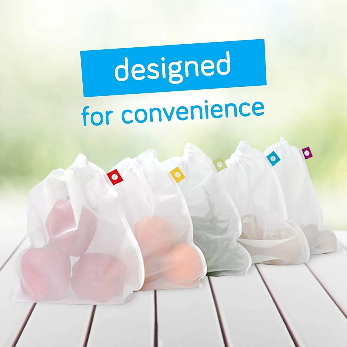 Five white cotton drawstring bags for kitchen vegetable storage arranged on a clean surface