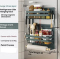 Black magnetic metal refrigerator side storage rack holding a tissue roll and a seasoning bottle