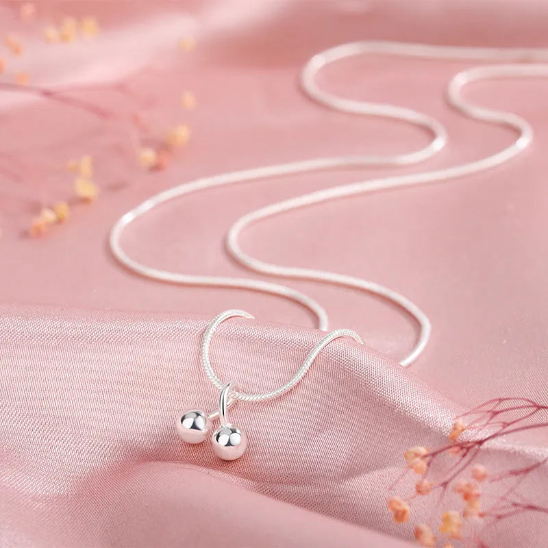 Silver cherry pendant necklace for women with adjustable snake chain.