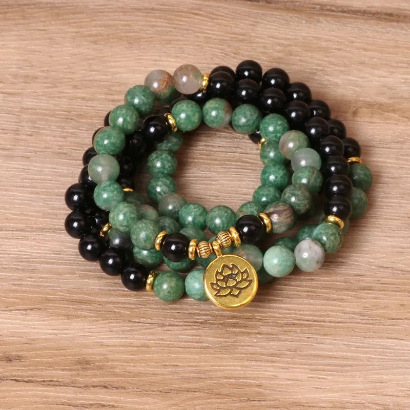 Green and black alloy elastic beaded long bracelet on a wrist, showing natural style design.